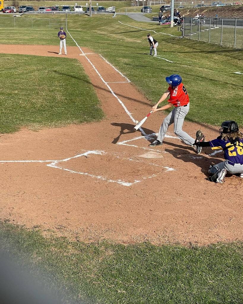 baseball player hitting the ball